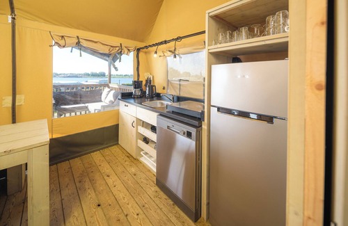 Lathum Casa | Experience luxury glamping in the elevated Safari Tent Ranger by the water.