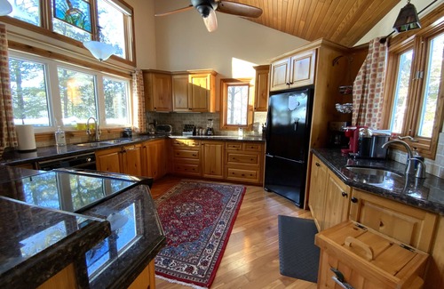 Windermere Cabaña | Log home & guest cottage in old forest, Waterfall, Sunsets, Sauna, Fishing Boat
