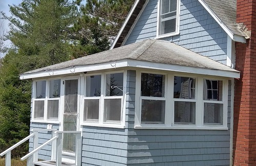 Dennysville Cabaña | Rustic, two-story, clapboard cottage, field view, Pet-friendly, Downeast Maine