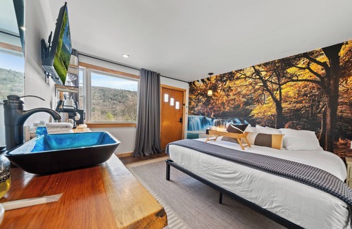 Hancock Hotel | Waterfall Retreat | Serene Room with Forest Mural at Green Acres Retreat