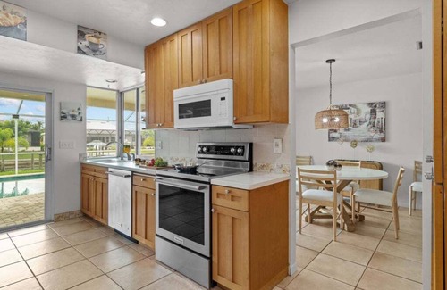 Caloosahatchee Casa | Waterfront Serenity beckons you to experience the ultimate canal-side retreat in stunning Cape Coral