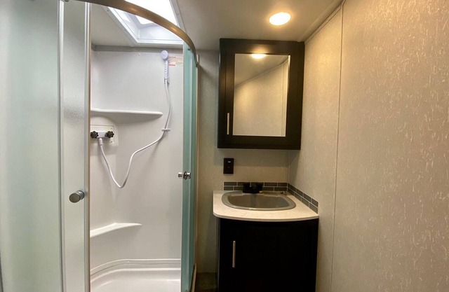 2 separate RV’s with queen-sized beds, dining area, and full kitchen.