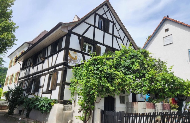 400-year-old half-timbered house in the village center by the village well