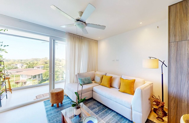 4th-floor condo with water view, on-site pool, private balcony, & W/D
