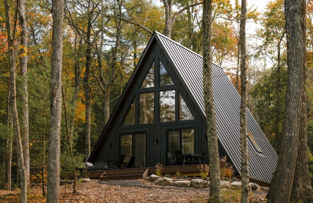 A modern A-frame, nestled in the woods with relaxing outdoor spaces and firepit.