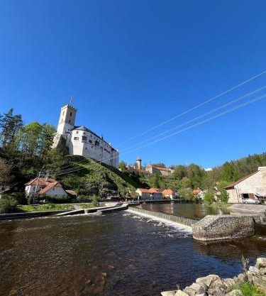 A room by a weir with a view of Rožmberk Castle