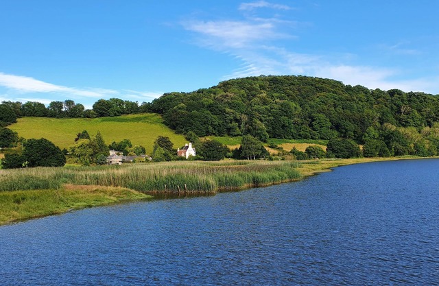 A secluded riverside cottage nestled in the Devon countryside.