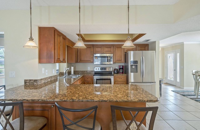 ABSOLUTELY GORGEOUS CANAL HOME WITH HEATED INGROUND POOL ON A QUIET STREET!!