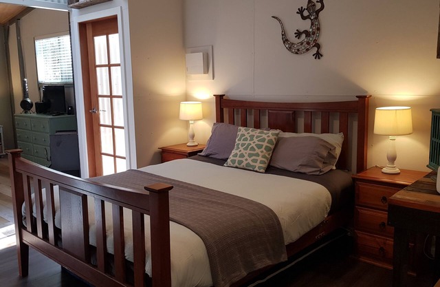 Adorable Guest House with fireplace in forest setting. One or two Queen Beds.