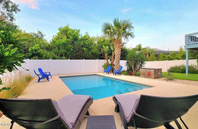 Amazing Tropical Pool Home with Breezy Outdoor Living Space just Steps to Beach.
