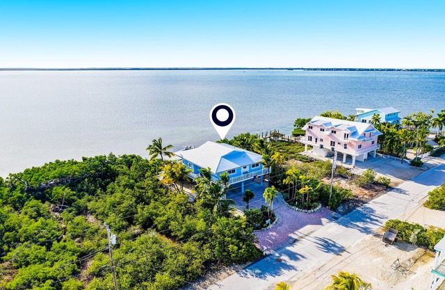 Amazing waterfront home with private beach, dock, pool, WiFi & outdoor kitchen