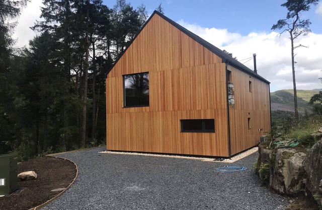 An Caisteal chalet sleeps up to 8 guests in 4 bedrooms with loch, mountain and waterfall view.