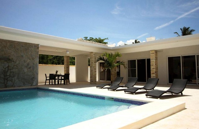 Beachfront bedroom in cozy villa with pool
