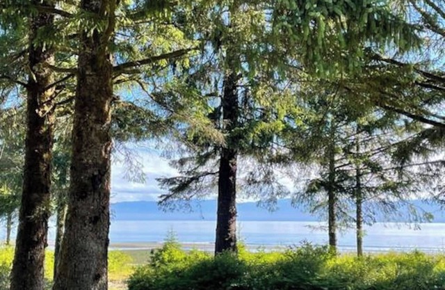 Walk out the front door, across a grass lawn and onto a sandy beach