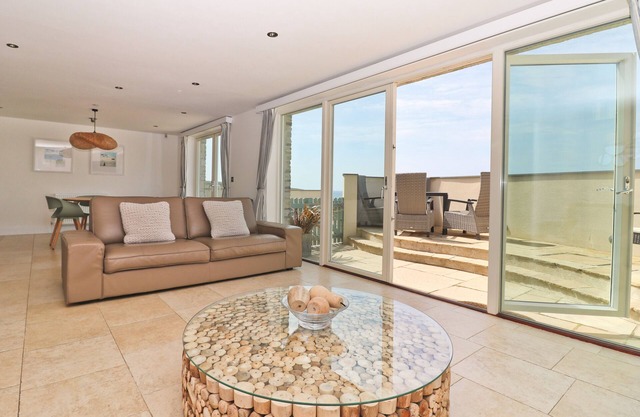 Beachside apartment with a private patio garden and beautiful sea views