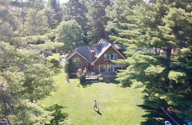 Beautiful lakeside home with private beach, access to golf, skiing, shopping.