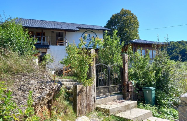 Bosnian house next to the Una river, with a view of the old Ostrovica fortress