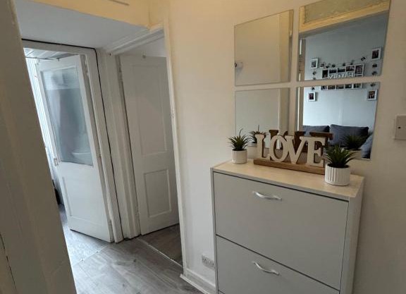 Bright bedroom with king side bed and share bathroom