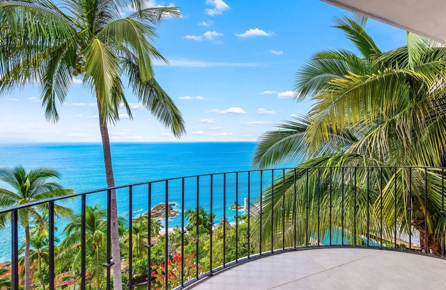 Bright ocean-view 2-story condo near beach with pool, balcony & full kitchen