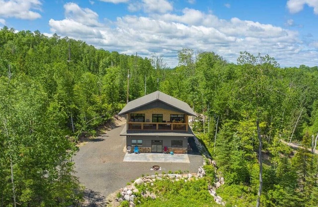Cabin is nestled in the woods near Lake Vermilion, offering breathtaking views.