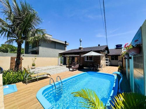 CASA GOLFINHO 348 - casa aconchegante com piscina, churrasqueira, mesa de sinuca e jogos