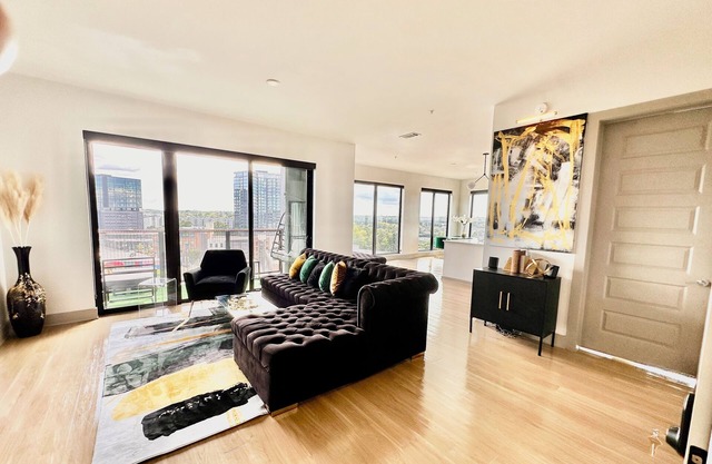 Ceiling to floor windows featuring a private balcony with stunning city views!