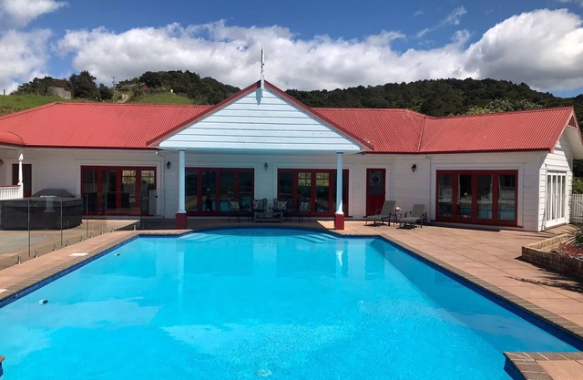 Charming hill top retreat with bay and mountain views.