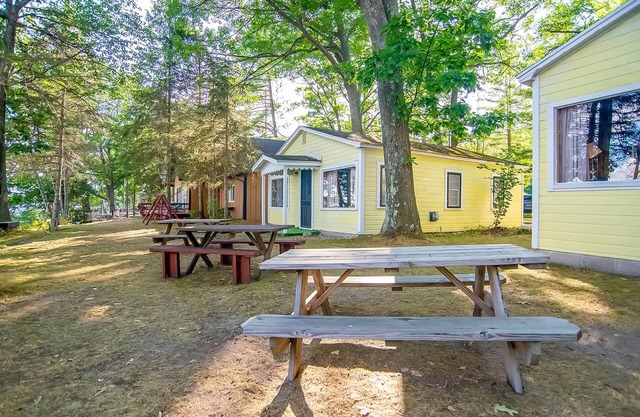 Charming lakefront cottage with large yard, dock, & fire pit - close to downtown