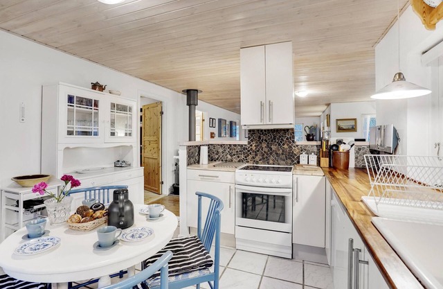 Classic vacation home with inviting eat-in kitchen, wood-burning stove, TV room and 3 bedrooms.