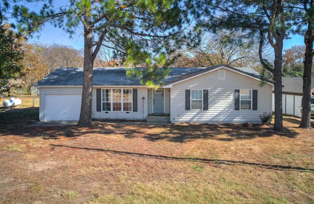 Close to Lake Eufala with a private firepit and covered back deck