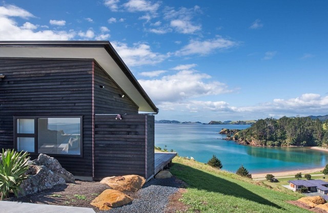 Coastal Gem. Great sea views, decks for outdoor living and safe swimming beach.