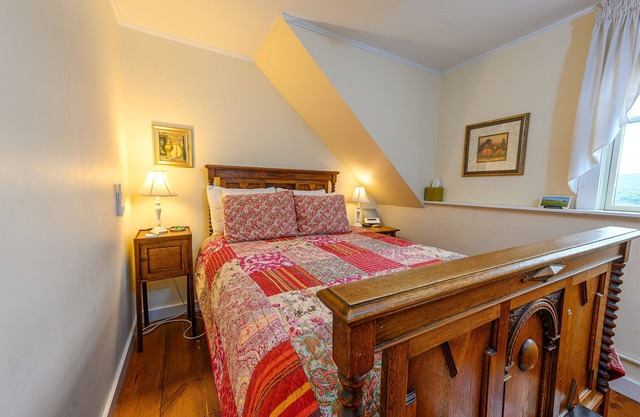 Comfortable budget room with queen bed, a stunning view of Mount Mansfield, and all-glass shower stall with full service breakfast included