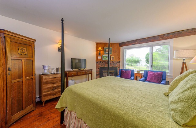 Comfortable, pet friendly room with queen bed, a stunning view of Mount Mansfield, sitting area and a fireplace with full service breakfast included