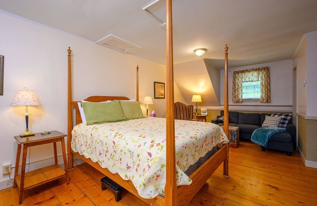 Comfortable room with queen bed and twin trundle, a stunning view of Mount Mansfield, sitting area with couch and a parlor stove with full service breakfast included