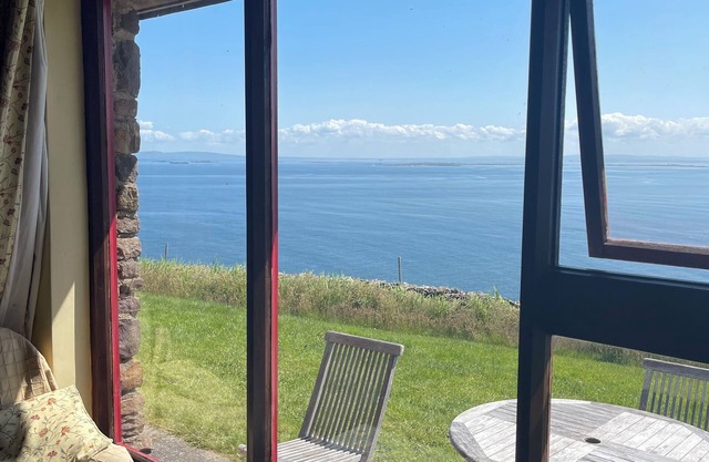 Cottage on Brandon Point on the Dingle Peninsula with sea and mountain views.
