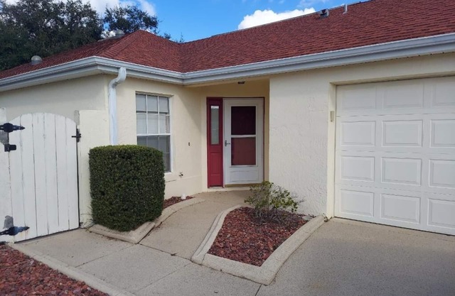 Courtyard Villa with gas golf cart located between two Town Squares!
