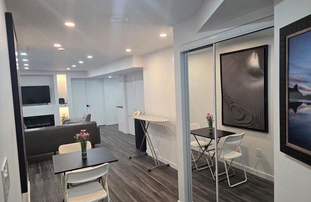 Cozy private basement suite | Fireplace, workspace & nature-inspired decor