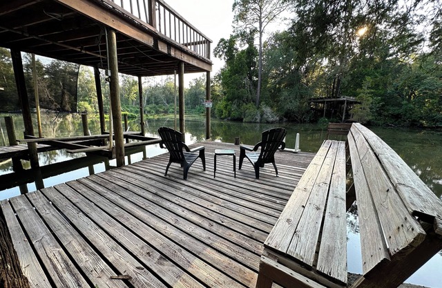 Cozy waterfront camp with dock and boat slip. Multiple outdoor spaces to enjoy!