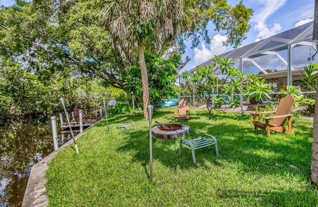 Creekside retreat with screened pool, patio, grill, firepit, canoe + kayak, & AC