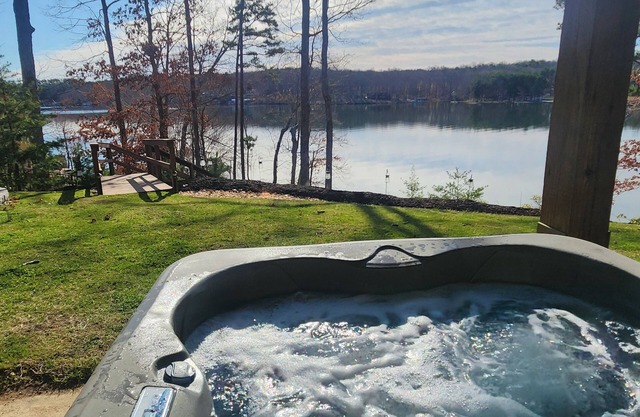 Custom-built lakefront home with lake views, firepit, fireplaces, dock, &HOT TUB