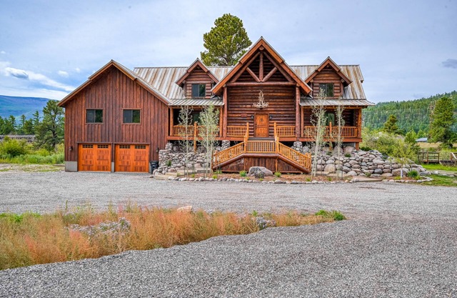 Custom riverfront log home w/ hot tub, decks & fireplace