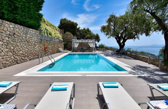 Dazzling Corfu Villa | Villa Poppy | 5 Bedrooms | Breathtaking Sea Views | Spacious Furnished Sun Terrace | Private Outdoor Pool | BBQ Facilities | Shaded Outdoor Dining Area | Children's Playground with Play Equipment | Table Tennis | Spartilas