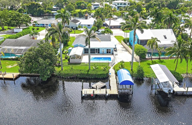 Deep water front home with private dock, pool, outdoor kitchen and pool table.