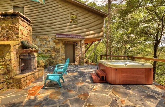 Discover River Bluff Retreat, a Pet-friendly haven with riverfront access for tubing and fishing, plus hot tub, outdoor fireplace, dock, and WiFi.