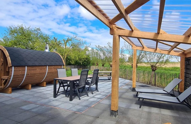 Discover this Dog-friendly vacation home in a quiet and natural setting, near the North Sea coast. Enjoy luxury amenities such as a Wood Burning Barrel Sauna, a private garden and comfortable bedrooms. Explore the surroundings by bike or take a trip