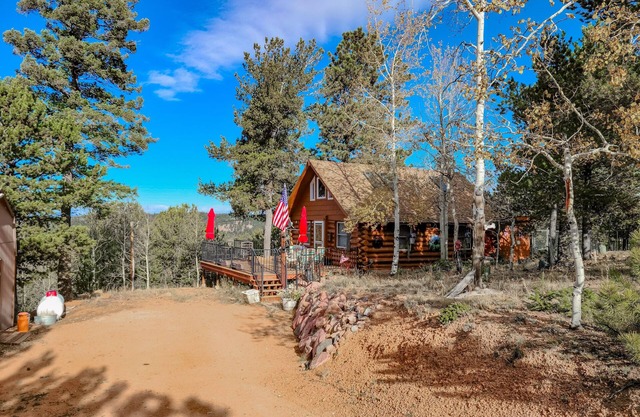 Dog-friendly cabin with mountain views, fireplace & wraparound deck