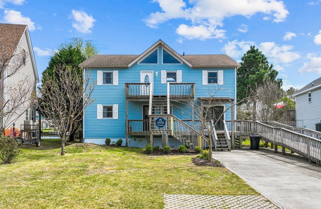 Dog-friendly home with canal views, dock, kayaks, sunroom, deck, & firepit