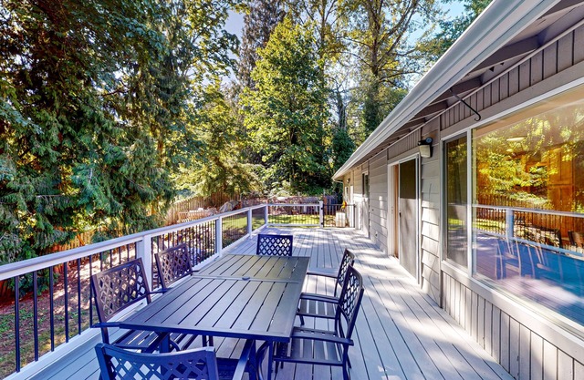 Dog-friendly home with large yard, inviting deck & spacious layout