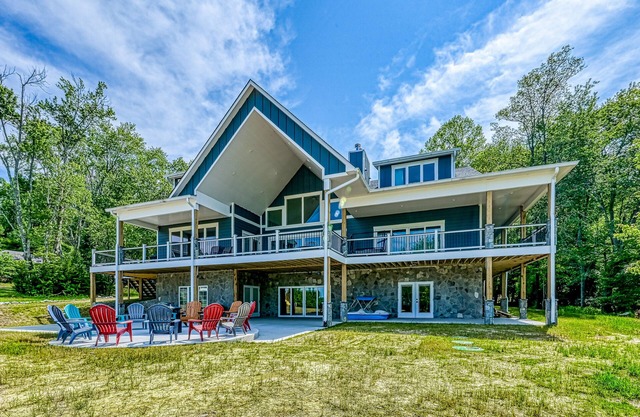 Dog-friendly lakefront home with a game room, children's items, and firepit
