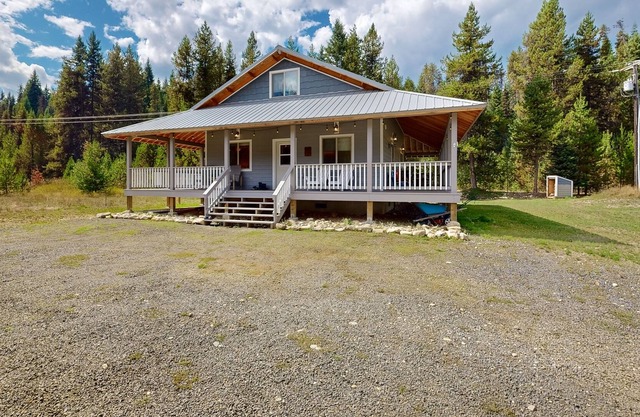 Dog-friendly riverfront home near town with deck, water views, & fireplace